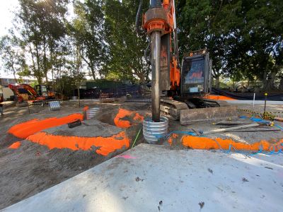 construction site with pile driver machinery