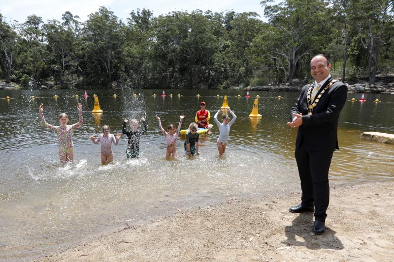 Lord Mayor standing on the shore of Lake Parramatta's upgraded swimming area