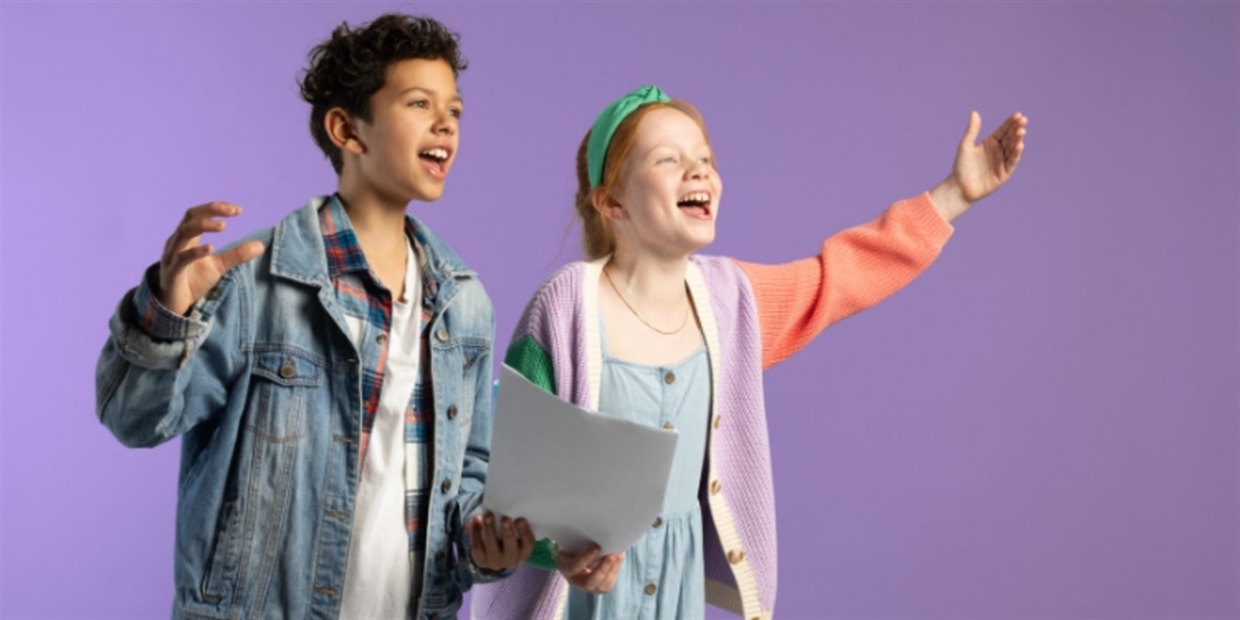 Two joyful children stand on a purple background. One wears a denim jacket, holding papers, and the other sports a colorful cardigan, both appearing to sing passionately.