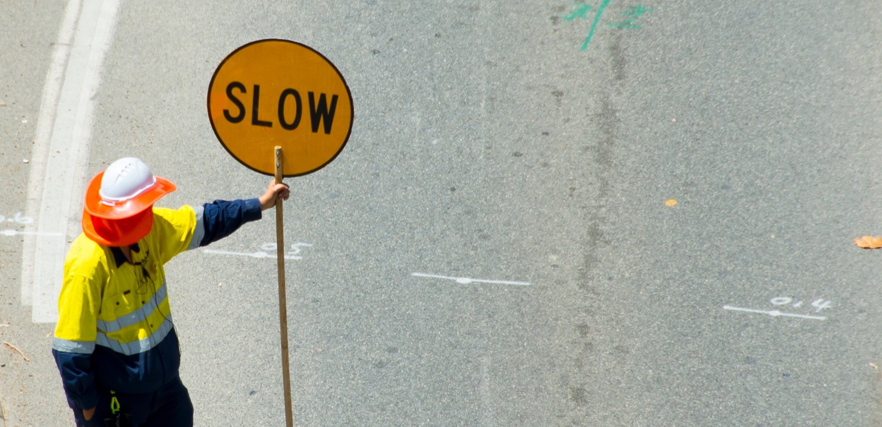 man with slow down sign