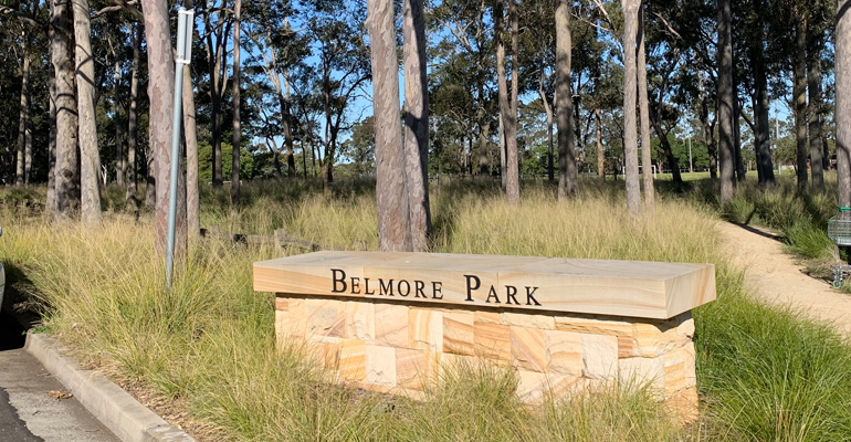 Belmore Park wall sign with trees and park in background