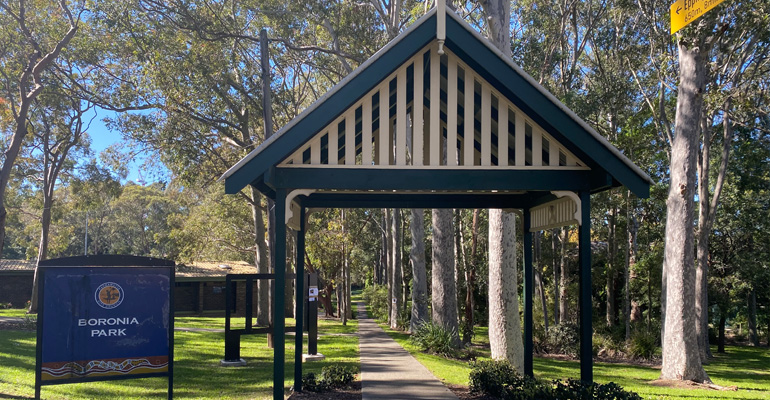 Boronia Park sign on left, wooden canopy on right and way finder sign