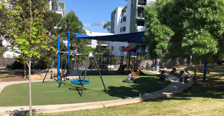 Playground partially shaded by trees