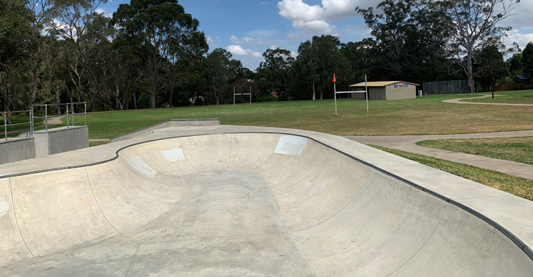 Skate bowl with amenities building in background