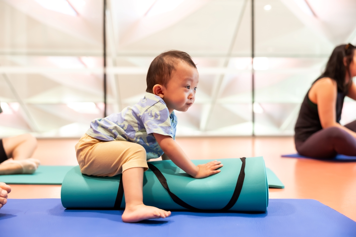 Baby on a rolled up mat