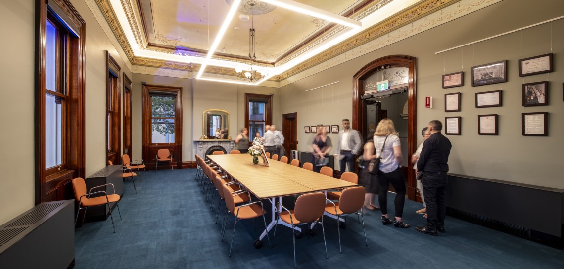 Long table in room with chairs near the window