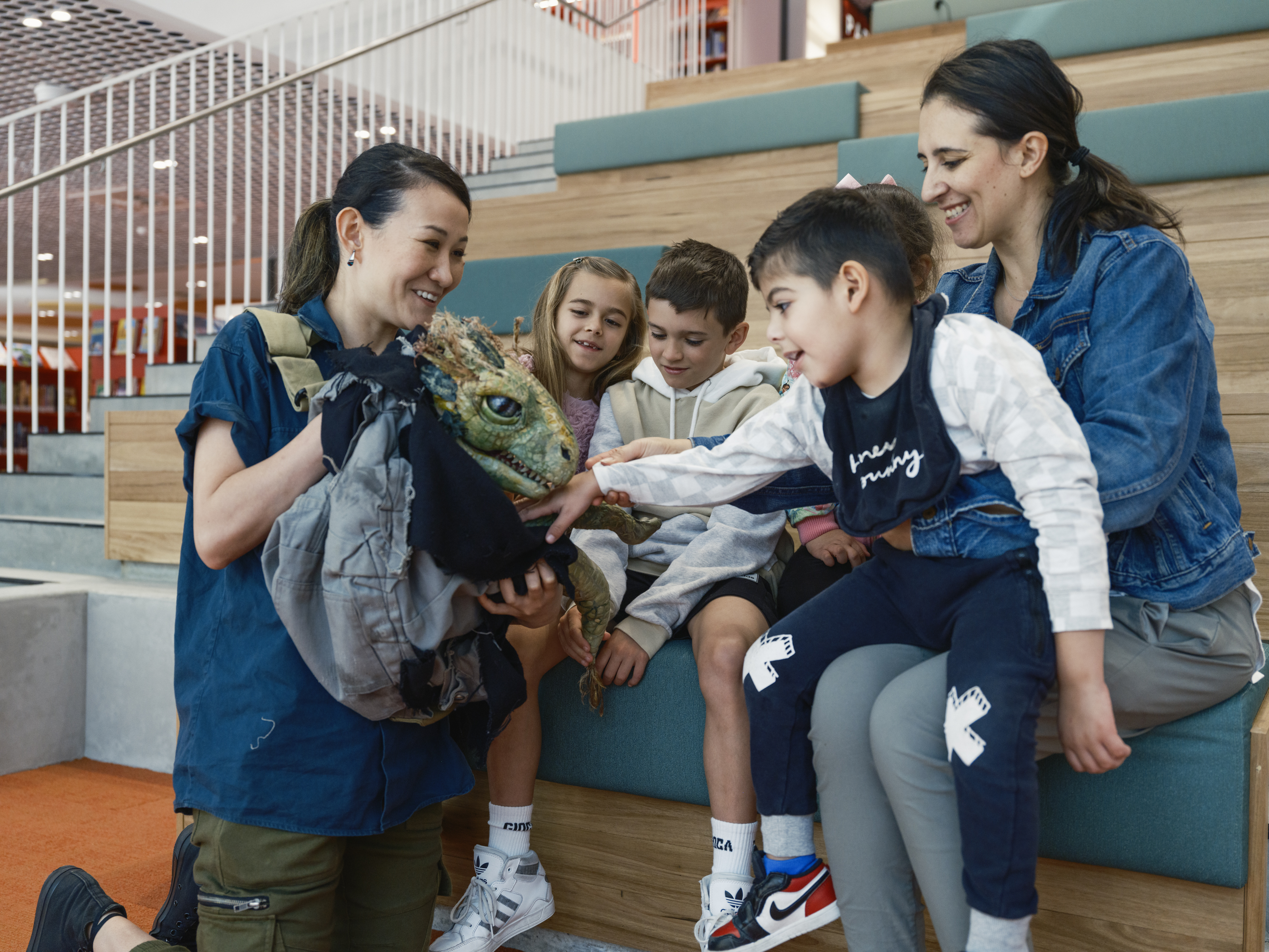 woman showcasing creature to young children