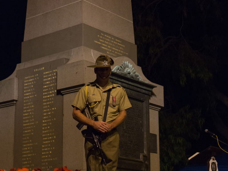 Solider in front on war memorial statue