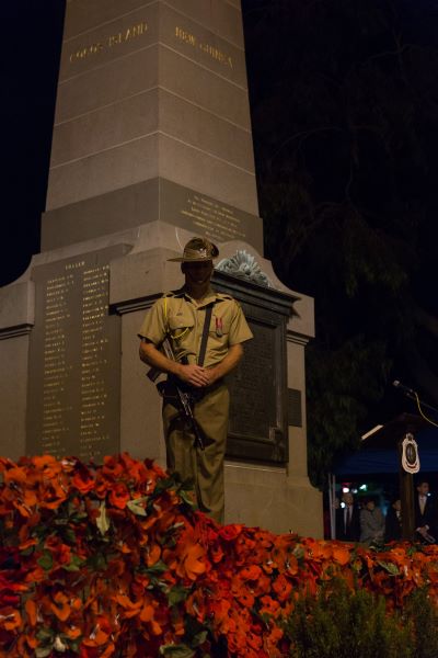 Solider standing in front of ANZAC Statue