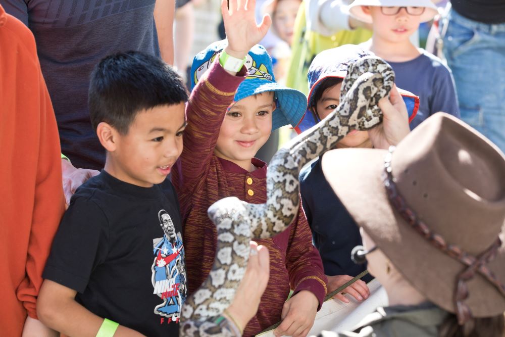Man showing Children a Snake