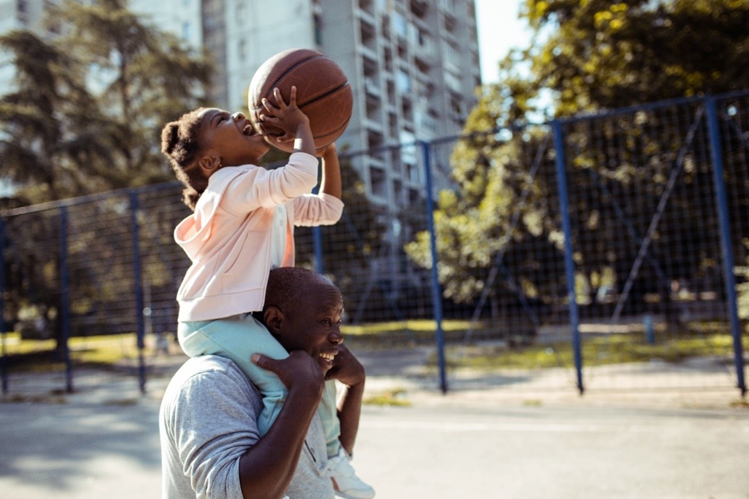 Father and daughter playing basketball