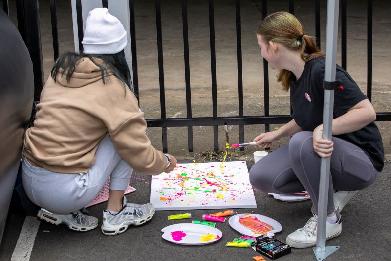 Two girls with paint brush painting