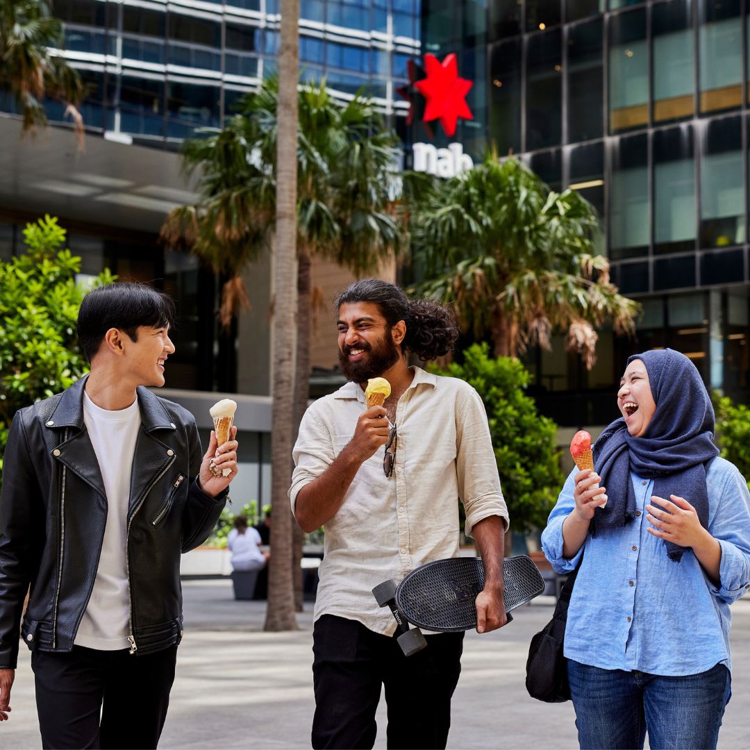 Three students eating ice cream in Parramatta Square