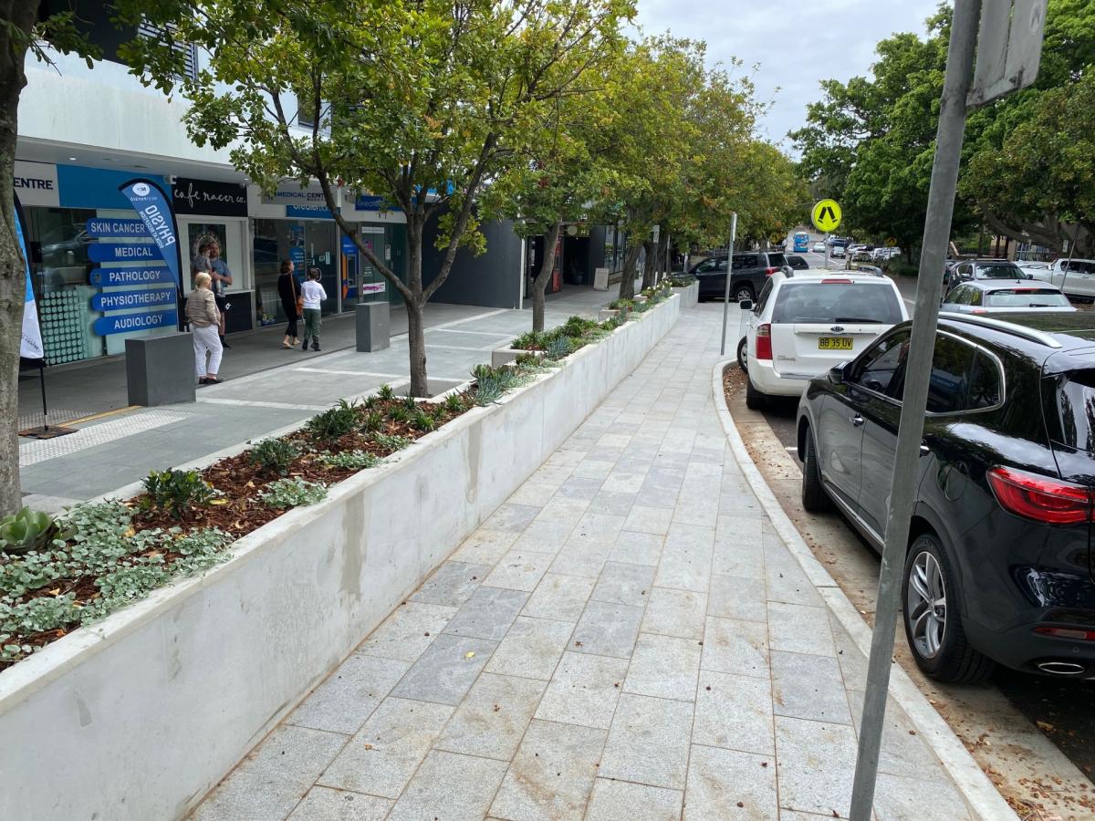New Kerb and planter boxes with cars parked along kerb
