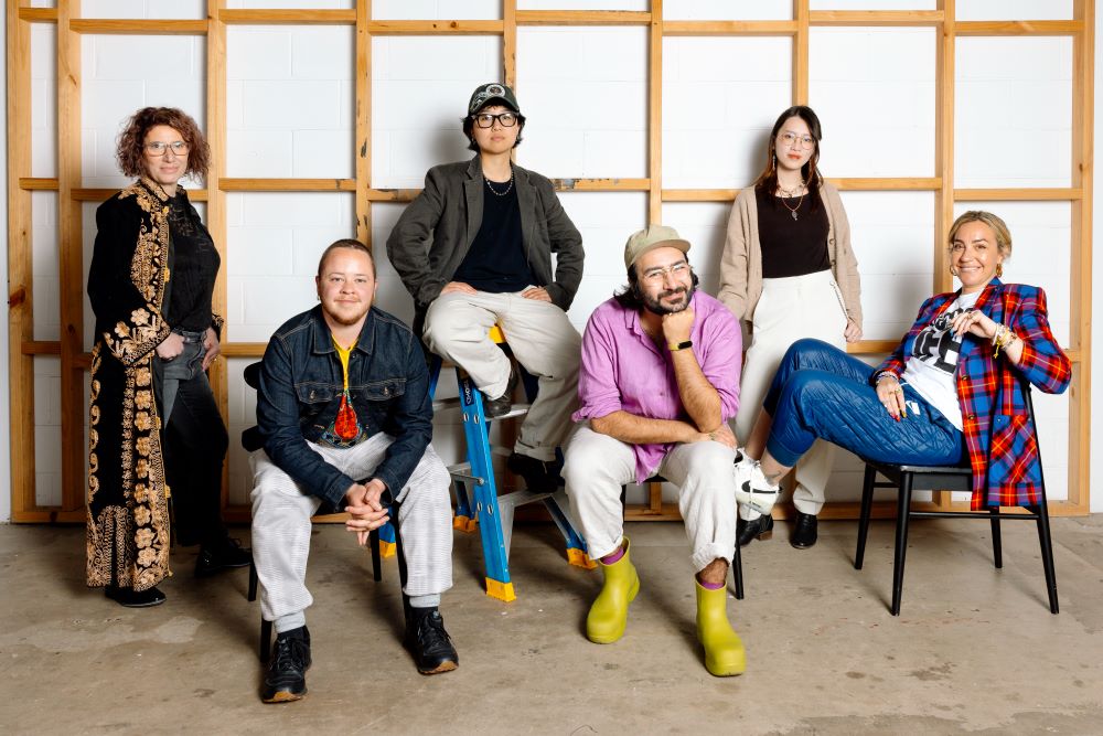 Men and women sitting on chairs, ladder