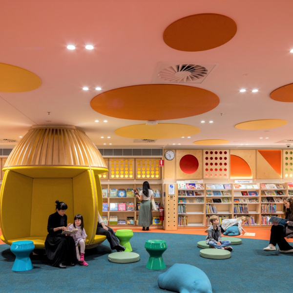 Woman and child reading book in library