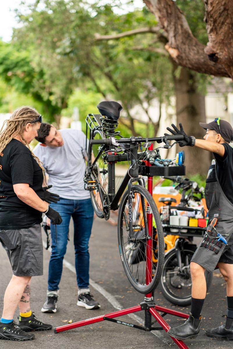 Three examining a bicycle