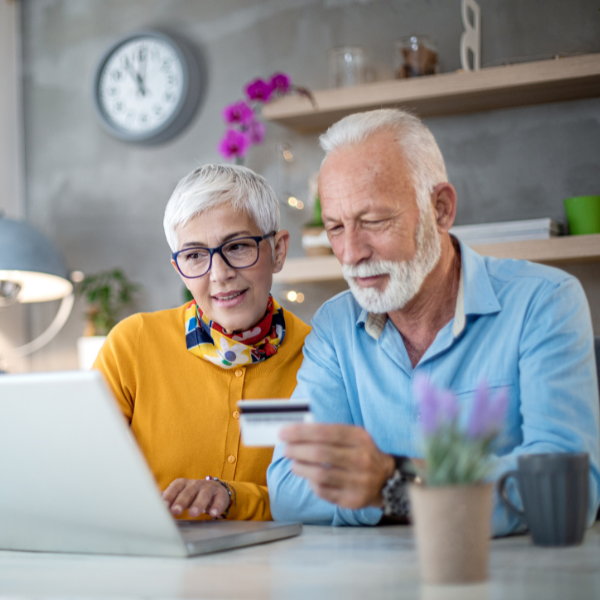 lady and man with white hair looking at computer