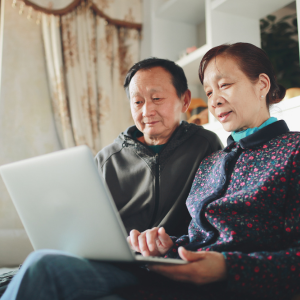 Two people looking at a laptop