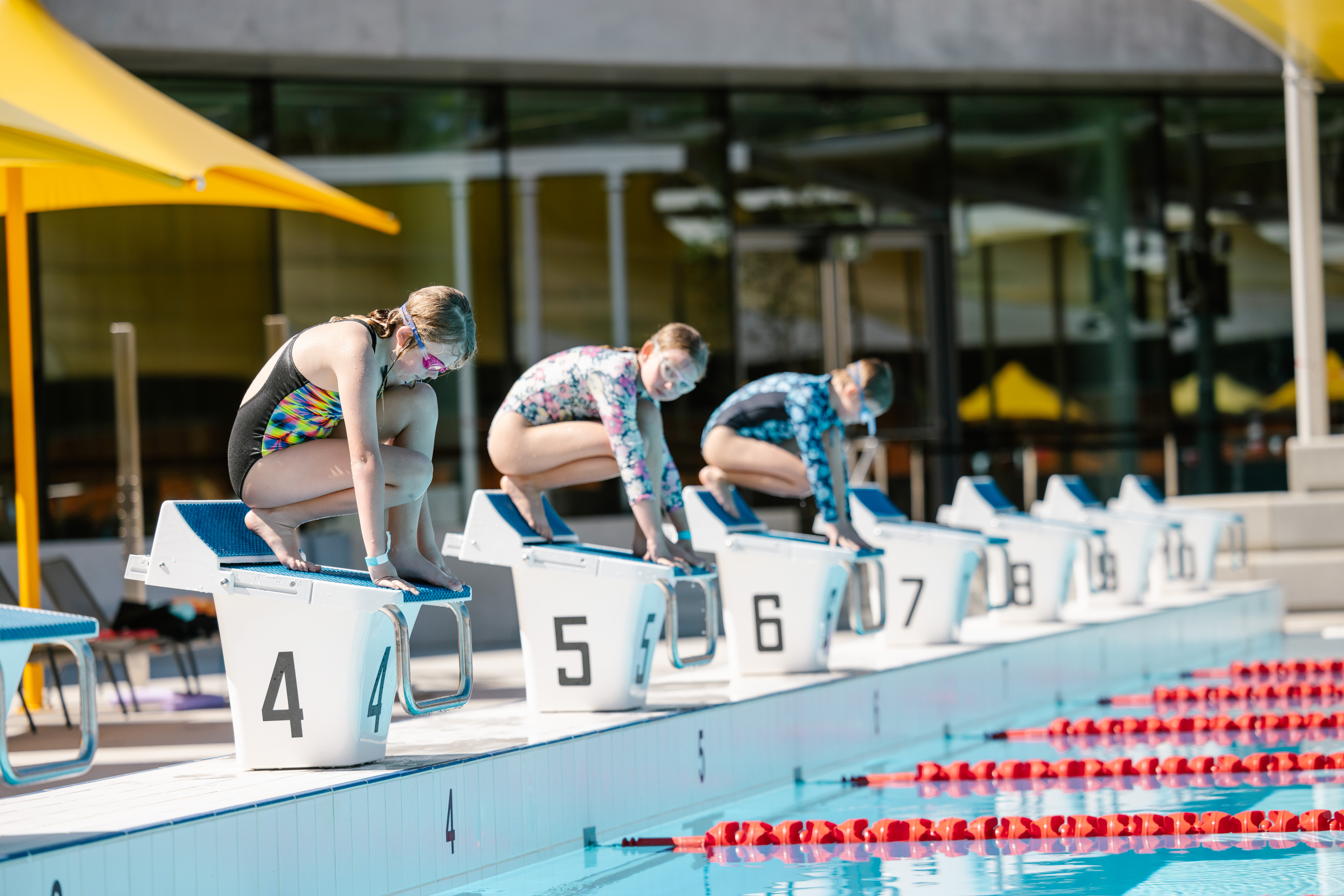 Young children at swimming pool starting line 