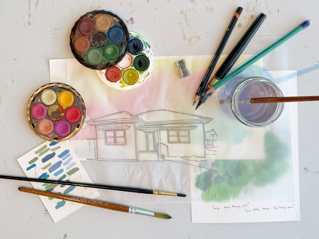 Watercolour paints, brushes and artwork