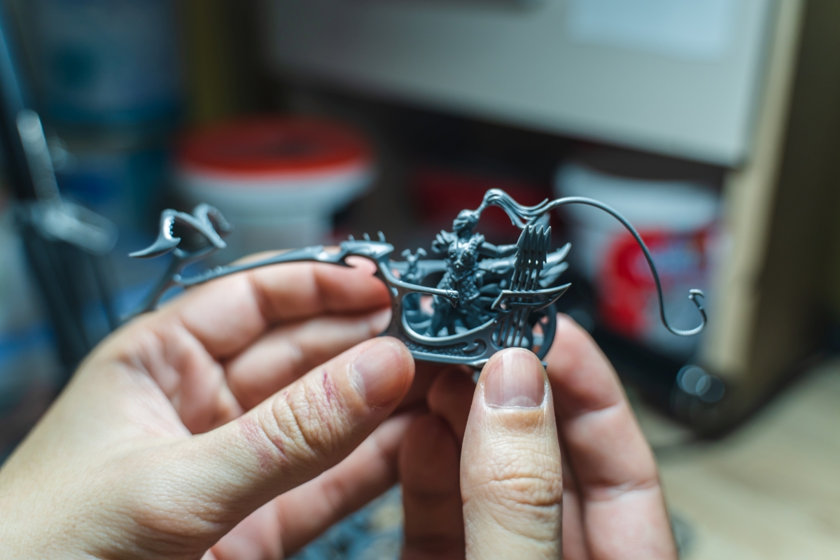 Hand holding mini figurine