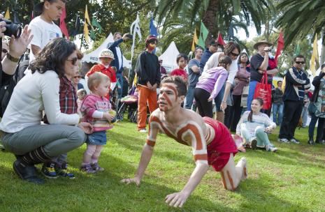 Families at Burramatta NAIDOC with small toddler interaction
