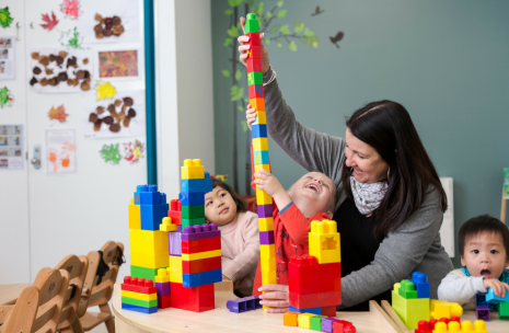 Young kids playing with building blocks